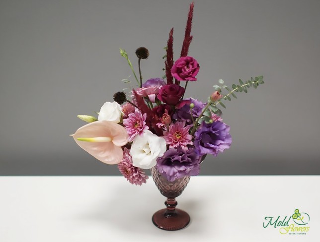 Composition in a glass with eustoma, chrysanthemum, anthurium, and eucalyptus photo